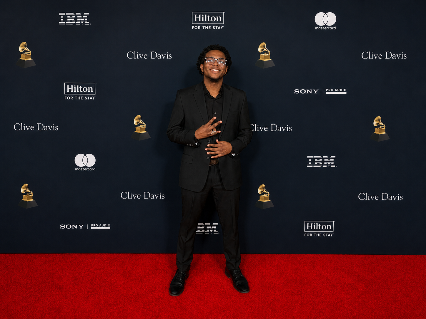 Kanjo &ldquo;Mr. Righteous&rdquo; standing on a red carpet at an entertainment industry event.