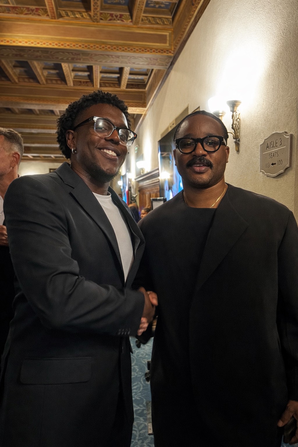 Ryan International team member Kanjo &ldquo;Mr. Righteous&rdquo; shaking hands with a guest at an industry event.